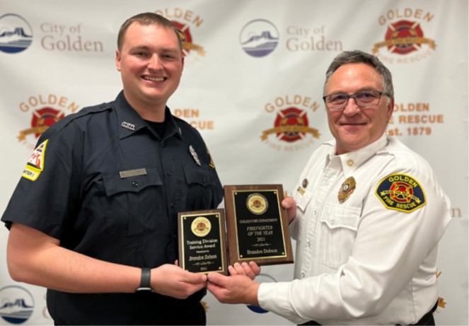 Brandon Dobson receives his award from Chief Jerry Stricker