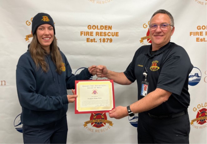 Brittnie Weiler receives her award from Chief Jerry Stricker