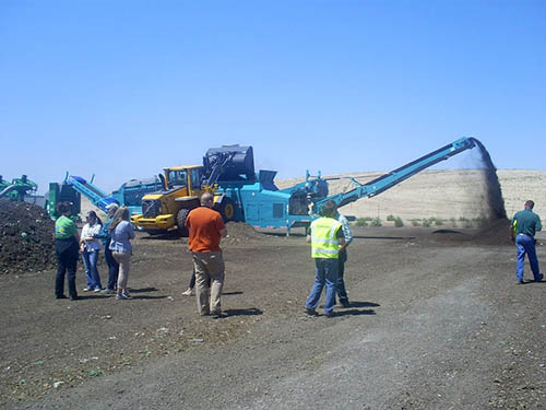 Giant machine turns over composting materials at the compost facility.