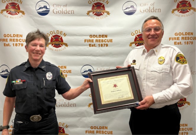 JJ Risch receives her award from Chief Jerry Stricker